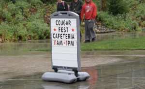 Sign advertising Cougar Fest in the rain on the College of the Canyons Campus